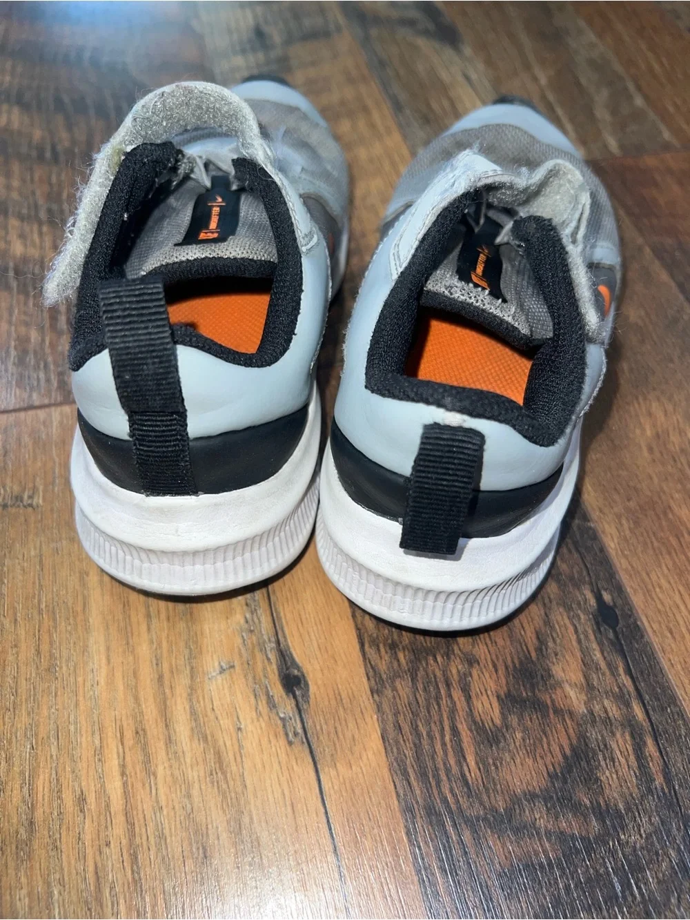 Nike Kids Light Gray and Black Sneakers with Orange Accents
